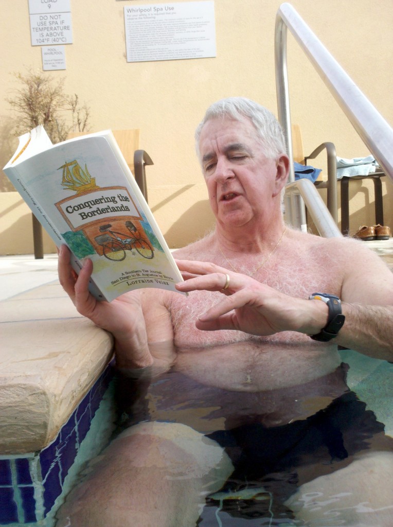 Tim reading "Conquering the Borderlands" while relaxing in hotel hot tub.