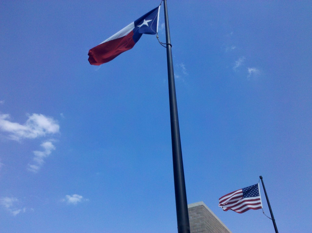 Texas and U.S. flags blowing in the direction we rode today.  Often in Texas, the state flag is somewhat larger than the U.S. flag (since Texas was a republic before it was a U.S. state), but these flags look to be the same size.